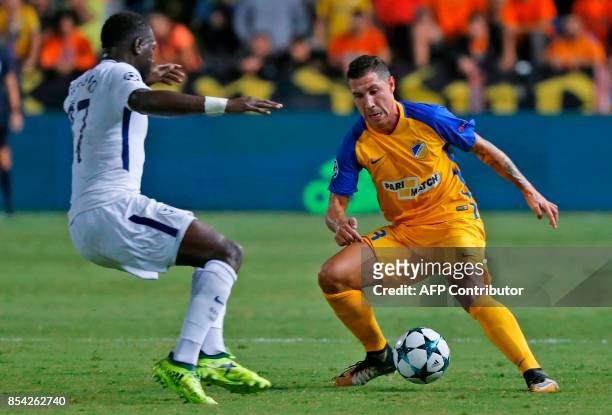 Tottenham Hotspur's French midfielder Moussa Sissoko vies for the ball with Apoel FC's Spanish defender Roberto Lago during the UEFA Champions League...