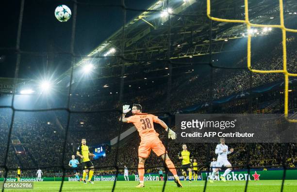 Real Madrid's forward from Wales Gareth Bale scores the opening goal past Dortmund's Swiss goalkeeper Roman Buerki during the UEFA Champions League...