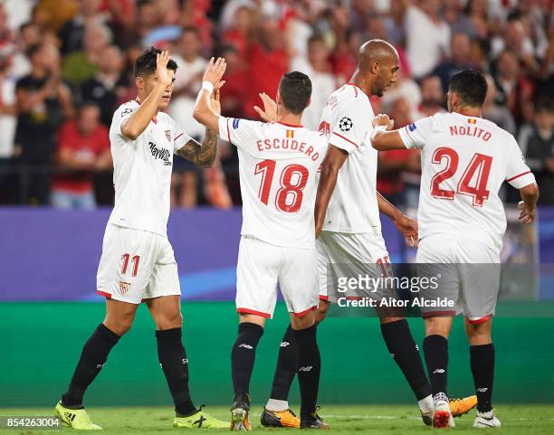Joaquin Correa of Sevilla FC celebrates after scoring his team mate Wissam Ben Yedder of Sevilla FC during the UEFA Champions League match between...