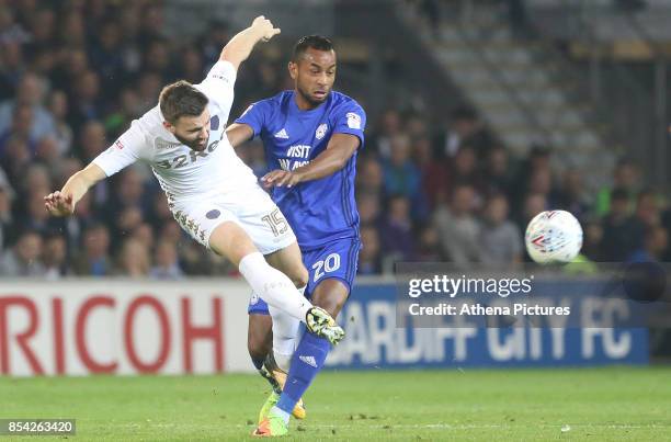 Stuart Dallas of Leeds United is challenged by Loic Damour of Cardiff City during the Sky Bet Championship match between Cardiff City and Leeds...