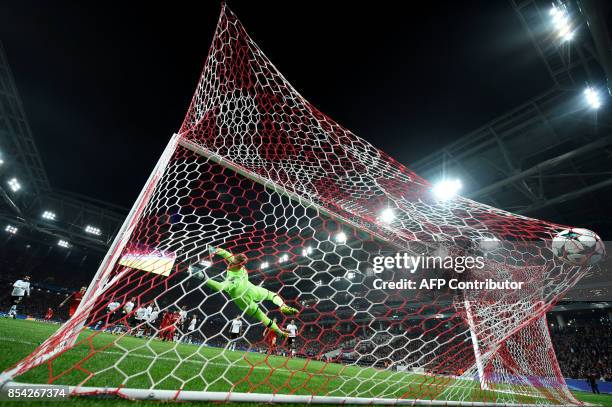 Liverpool's goalkeeper from Germany Loris Karius fails to stop the ball during the UEFA Champions League Group E football match between FC Spartak...