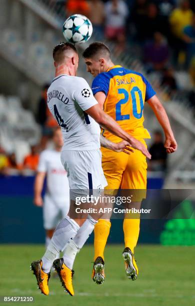 Tottenham's Belgian defender Toby Alderweireld vies for the header with APOEL Nicosia's Hungarian midfielder Roland Sallai during the UEFA Champions...