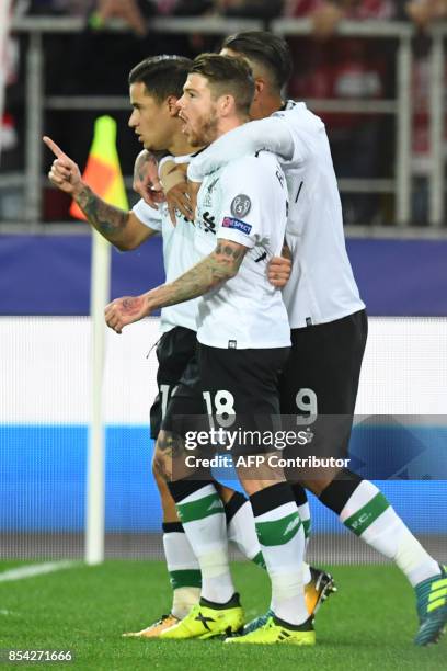 Liverpool's midfielder from Brazil Philippe Coutinho Correia celebrates with teammates after scoring a goal during the UEFA Champions League Group E...