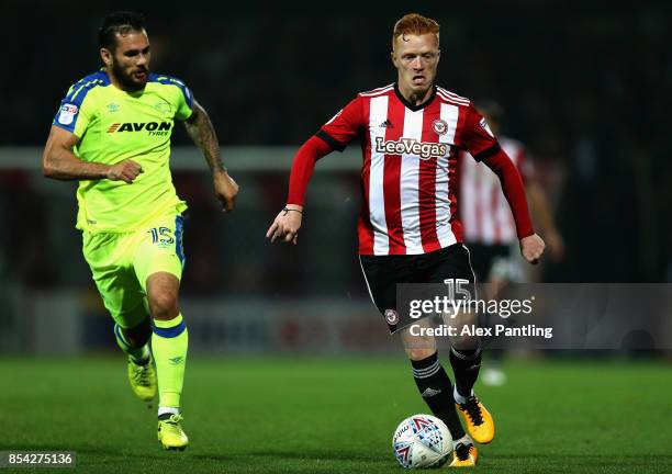 Bradley Johnson of Derby County chases down Ryan Woods of Brentford during the Sky Bet Championship match between Brentford and Derby County at...