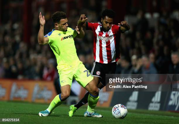 Mason Bennett of Derby County tackles Rico Henry of Brentford during the Sky Bet Championship match between Brentford and Derby County at Griffin...