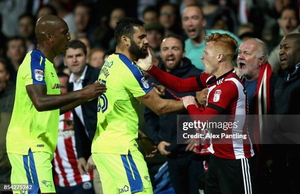 Bradley Johnson of Derby County and Ryan Woods of Brentford clash during the Sky Bet Championship match between Brentford and Derby County at Griffin...