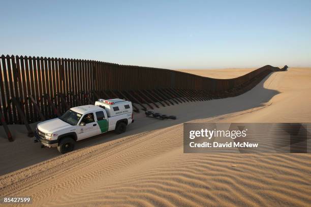 Border patrol vehicle drags the sand to make any new footprints of border crossers more visible along a recently constructed section of the...