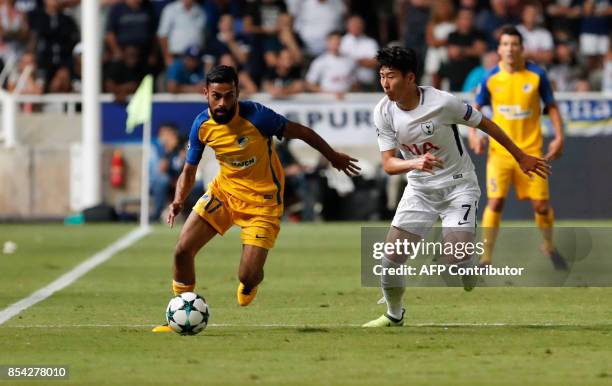 Apoel FC's Norwegian midfielder Ghayas Zahid is marked by Tottenham's South Korean forward Heung-min Son during the UEFA Champions League football...