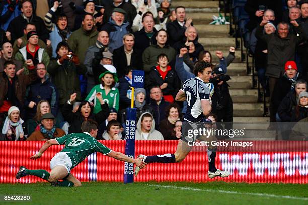 Thom Evans of Scotland gets past Ronan O'Gara of Ireland to score a try during the RBS Six Nations Championship match between Scotland and Ireland at...