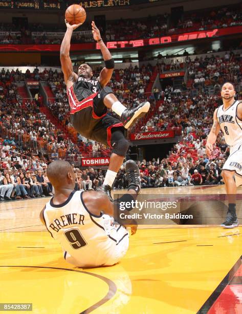 Dwyane Wade of the Miami Heat shoots against Ronnie Brewer of the Utah Jazz on March 14, 2009 at the American Airlines Arena in Miami, Florida. NOTE...