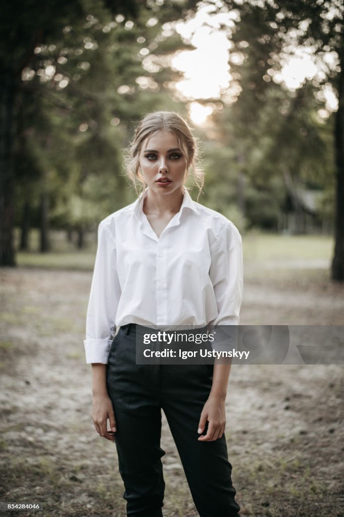 Woman in black pants and white shirt  on ranch