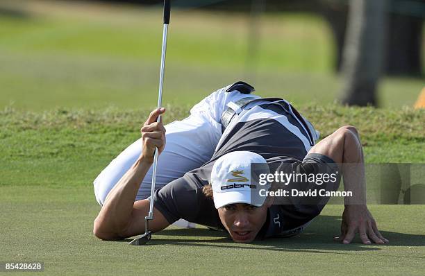 Camilo Villegas of Colombia lines up a putt at the 16th hole during the third round of the World Golf Championships-CA Championship at the Doral Golf...