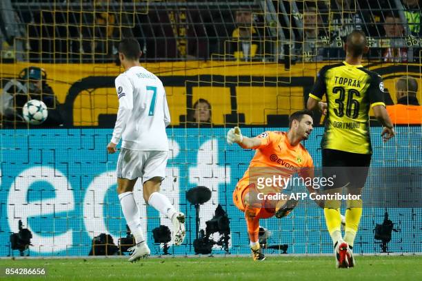 Real Madrid's forward from Portugal Cristiano Ronaldo scores during the UEFA Champions League Group H football match BVB Borussia Dortmund v Real...