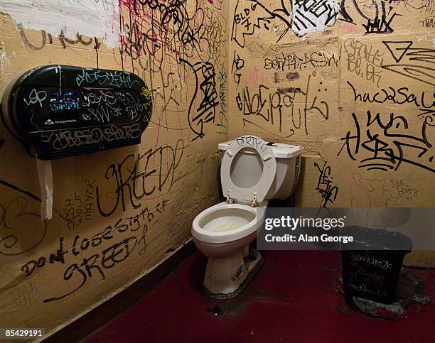 public toilet with graffiti on wall - public restroom stock-fotos und bilder