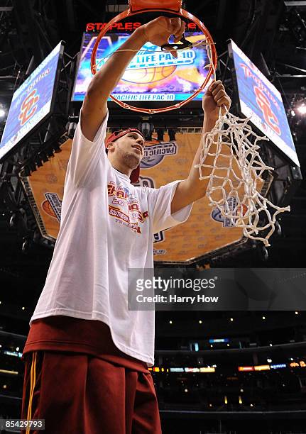 Guard Daniel Hackett of the USC Trojans cuts down the net after winning the Pacific Life Pac-10 Men's Basketball Tournament Championship Game against...