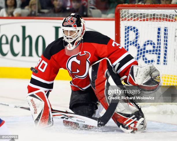 Martin Brodeur of the New Jersey Devils watches the incoming puck during the game against the Montreal Canadiens at the Bell Centre on March 14, 2009...