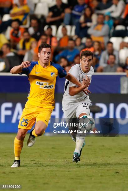 Apoel FC's Argentine midfielder Agustin Farias is marked by Tottenham Hotspur's English midfielder Harry Winks during the UEFA Champions League...