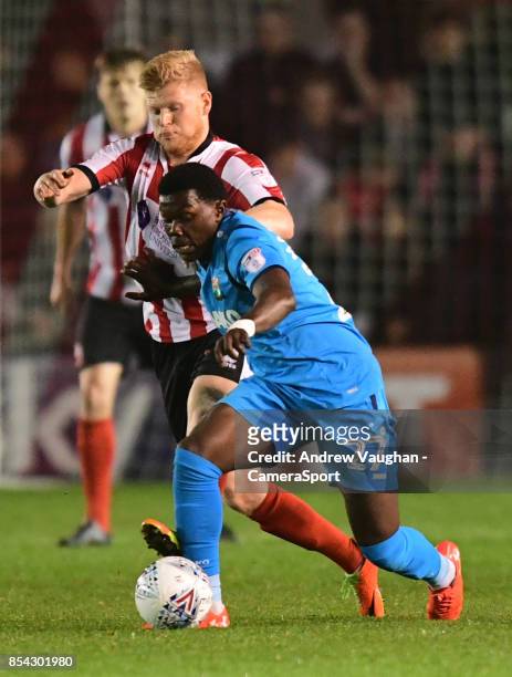 Lincoln City's Elliott Whitehouse vies for possession with Barnet's Ephron Mason-Clark during the Sky Bet League Two match between Lincoln City and...