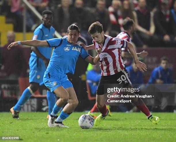 Lincoln City's Alex Woodyard vies for possession with Barnet's Ruben Bover during the Sky Bet League Two match between Lincoln City and Barnet at...