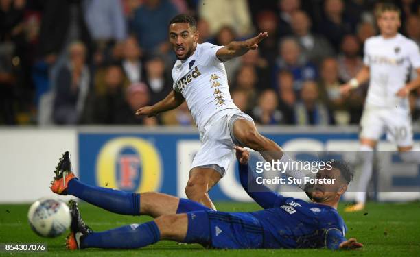Leeds player Kemar Roofe gets a shot in at goal despite the challenge of Sean Morrison during the Sky Bet Championship match between Cardiff City and...