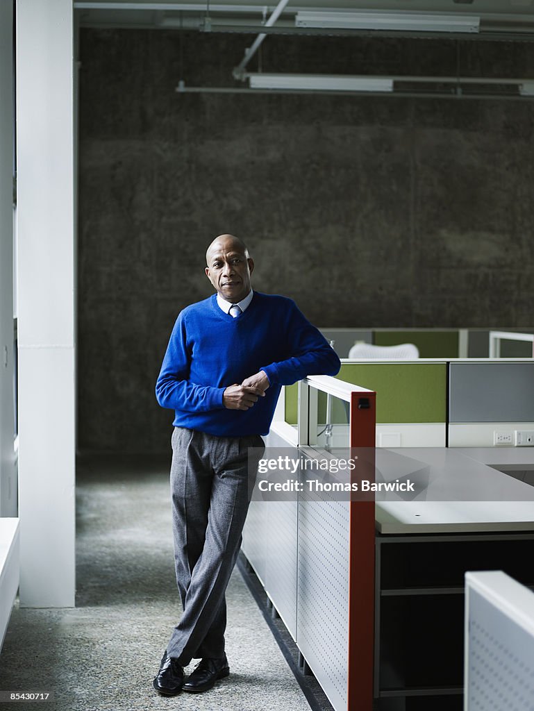 Businessman leaning on workstation