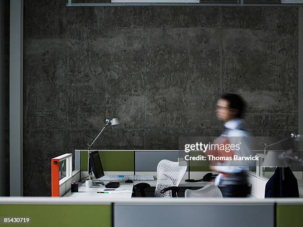 businessman walking with documents - blurry office stock-fotos und bilder