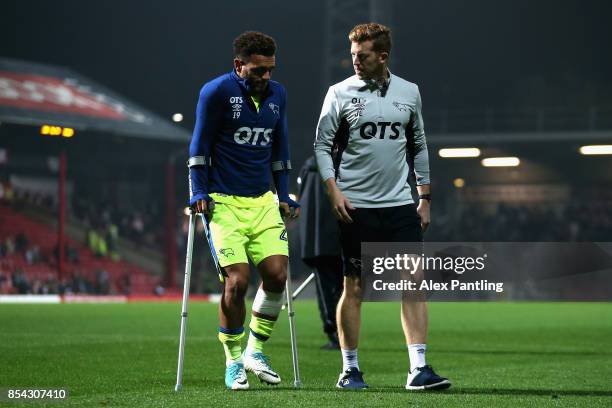 An injured Mason Bennett of Derby County leaves the pitch on crutches during half time of the Sky Bet Championship match between Brentford and Derby...