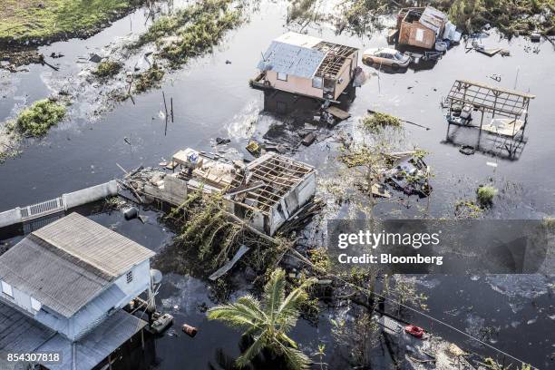 Destroyed homes and vehicles sit in floodwaters after Hurricane Maria in this aerial photograph taken above Hamacao, Puerto Rico, on Monday, Sept....