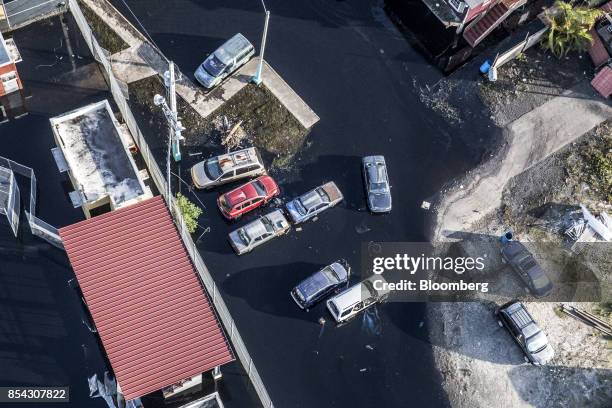 Destroyed homes and vehicles sit in floodwaters after Hurricane Maria in this aerial photograph taken above Hamacao, Puerto Rico, on Monday, Sept....