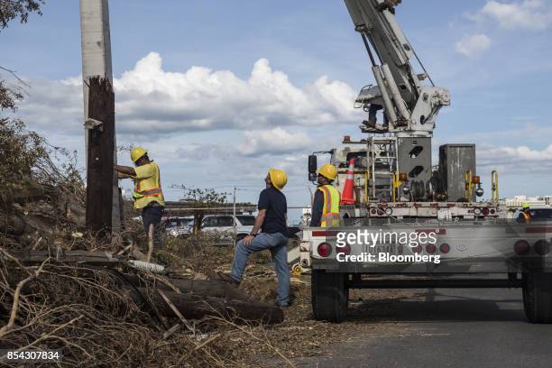 Puerto Rico Electric Power Authority workers evaluate a utility pole destroyed from Hurricane Maria outside the Fernando Luis Ribas Dominicci...