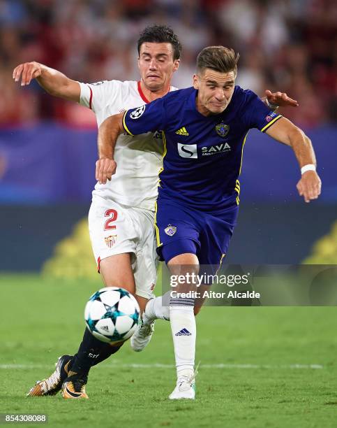 Sebastien Corchia of Sevilla FC competes for the ball with Blaz Vrhovec of NK Maribor during the UEFA Champions League match between Sevilla FC and...