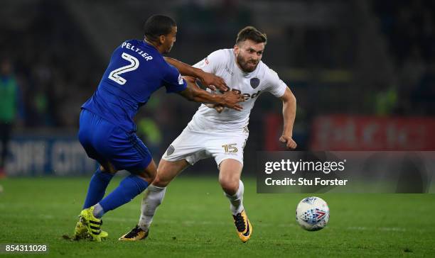 Cardiff defender Lee Peltier challenges Stuart Dallas of Leeds during the Sky Bet Championship match between Cardiff City and Leeds United at Cardiff...