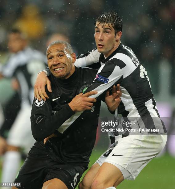 Celtic's Kelvin Wilson is held by Juventus' Federico Peluso in the penalty area