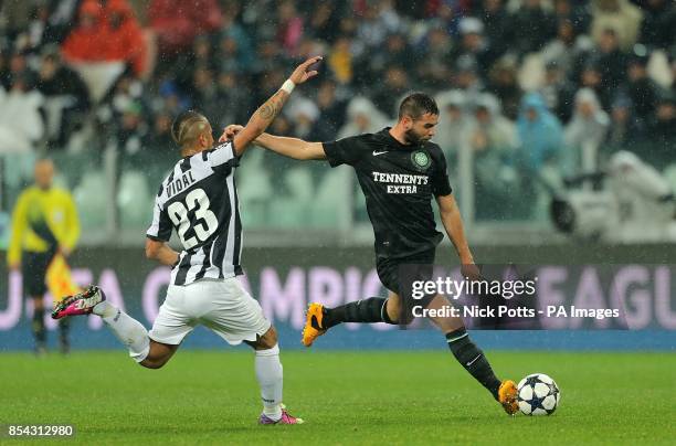 Juventus' Arturo Vidal tries to stop Celtic's Joe Ledley from having a shot on goal