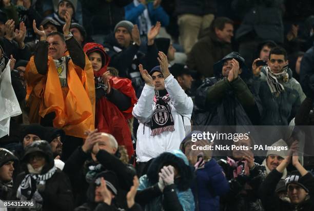 Juventus fans applaud the Celtic fans in the stands