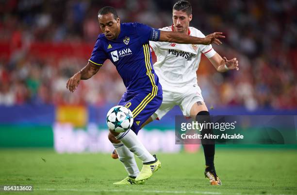 Marcos Tavares of NK Maribor competes for the ball with Sergio Escudero of Sevilla FC during the UEFA Champions League match between Sevilla FC and...