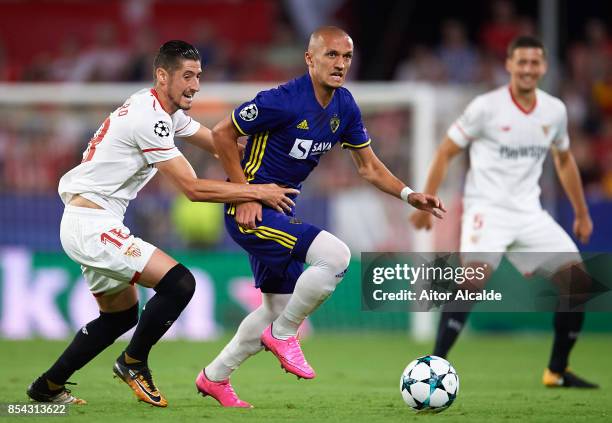 Sergio Escudero of Sevilla FC competes for the ball with Valon Ahmedi of NK Maribor during the UEFA Champions League match between Sevilla FC and NK...