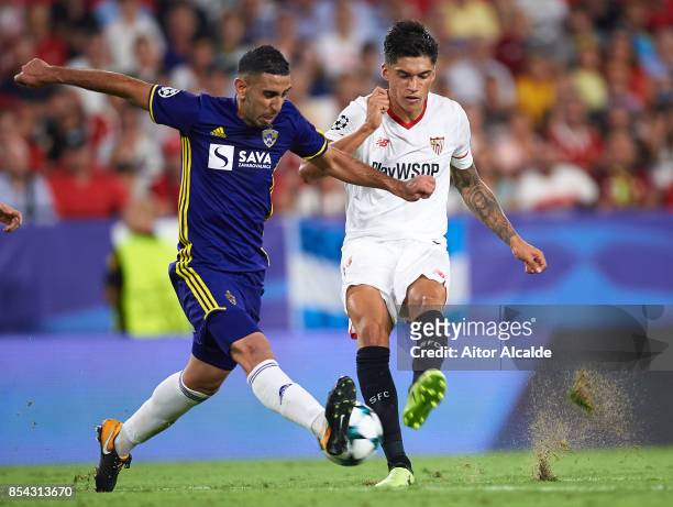 Marwan Kabha of NK Maribor competes for the ball with Joaquin Correa of Sevilla FC during the UEFA Champions League match between Sevilla FC and NK...