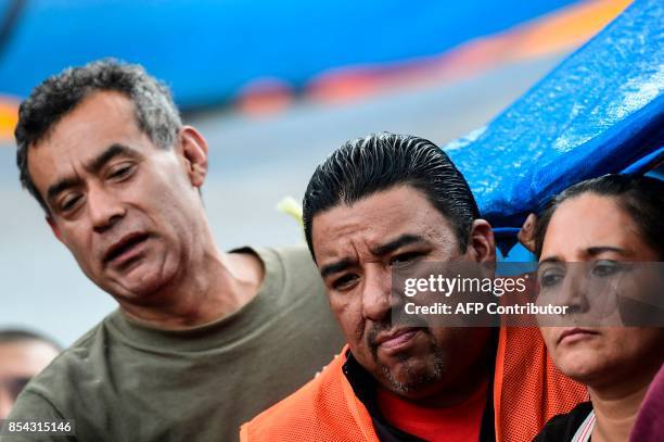 Relatives of people who are presumed still buried under the rubble from a building toppled by the 7.1-magnitude quake that struck central Mexico one...