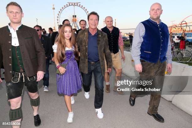 Stella Glaubitz, granddaughter of Guenter Heinlein, Arnold Schwarzenegger and his bodyguard Fabian Pomplun leave the Oktoberfest at Theresienwiese on...