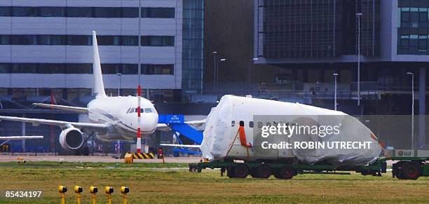 The wreck of a Turkish airlines Boeing 737-800 that crashed near Amsterdam two and a half weeks ago is transported to Schiphol airport on March 15,...