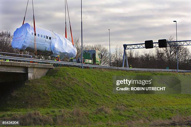 The wreck of a Turkish airlines Boeing 737-800 that crashed near Amsterdam two and a half weeks ago is transported to Schiphol airport on March 15,...