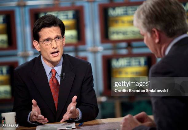 Moderator David Gregory listens while Rep. Eric Cantor , House Republican Whip, speaks during a live taping of 'Meet the Press' at NBC studios March...