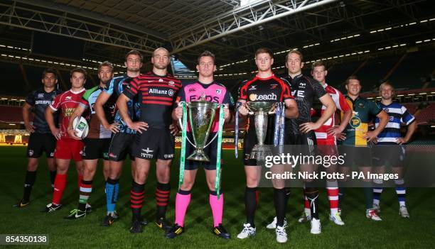 Cardiff Blues captain Matthew Rees with the Heineken Cup and Newport Gwent Dragons captain Andrew Coombs holding the Amlin Challenge Cup with fellow...