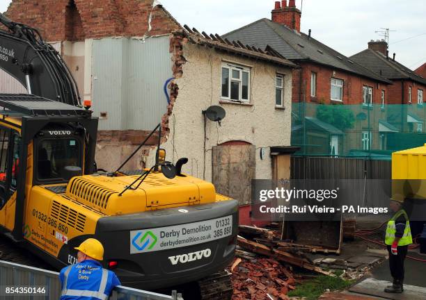 Demolition work begins on Mick and Mairead Philpott's old family home on Victory Road, Derby, where the two parents set a deadly fire which killed...