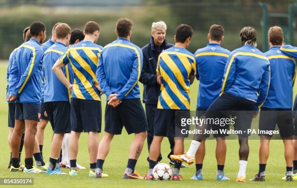 Arsenal's manager Arsene Wenger chats with his players during a training session at London Colney, Hertfordshire.