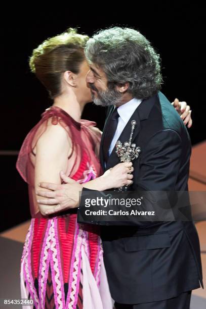 Ricardo Darin receives the Donostia Award from actress Dolores Fonzi at the Kursaal Palace during the 65th San Sebastian International Film Festival...