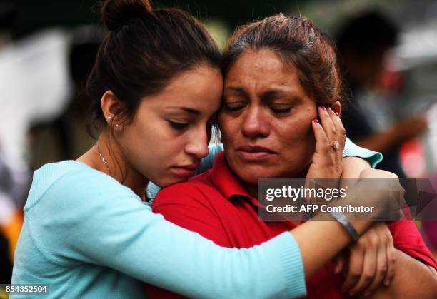 Relatives of people who are presumed still buried under the rubble from a building toppled by the 7.1-magnitude quake that struck central Mexico one...