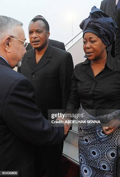 The late first lady of Gabon's father and president of Congo Denis Sassou Nguesso , looks on as his wife shakes hands with Moroccan Justice Minister...