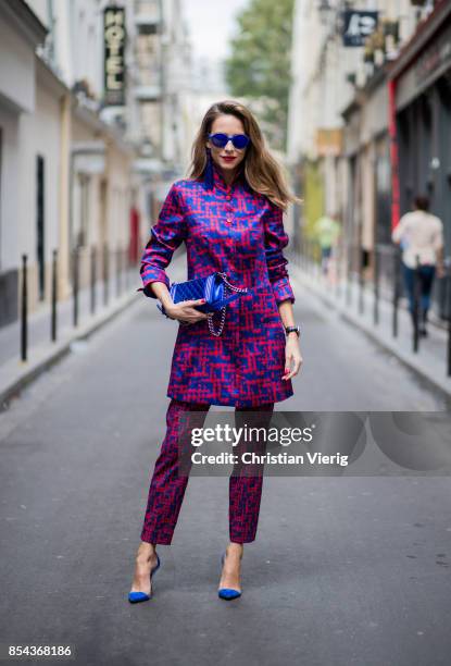 Alexandra Lapp wearing a two-piece in red and blue by Riani, a blue lacquer Chanel Boy bag, blue sunglasses by Etnia Barcelona, plexi pumps in blue...